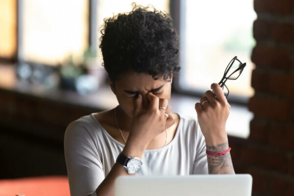 Woman rubbing her dry eyes