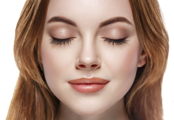 Closeup of beautiful woman's face with eyes closed and long lashes