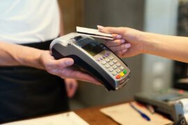 Customer paying for service on credit card machine
